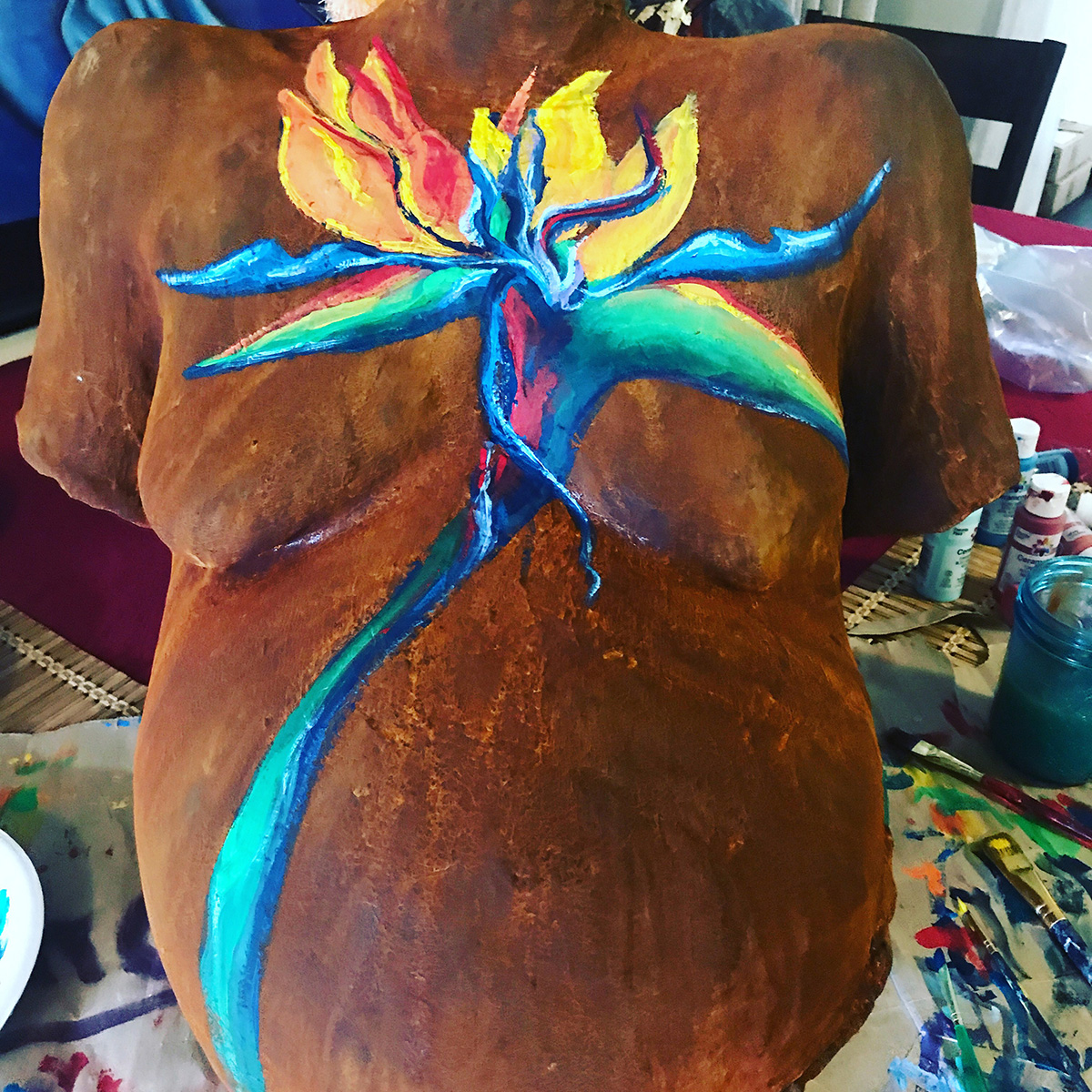 Bellycast with rust finish and bird of paradise flower painting
